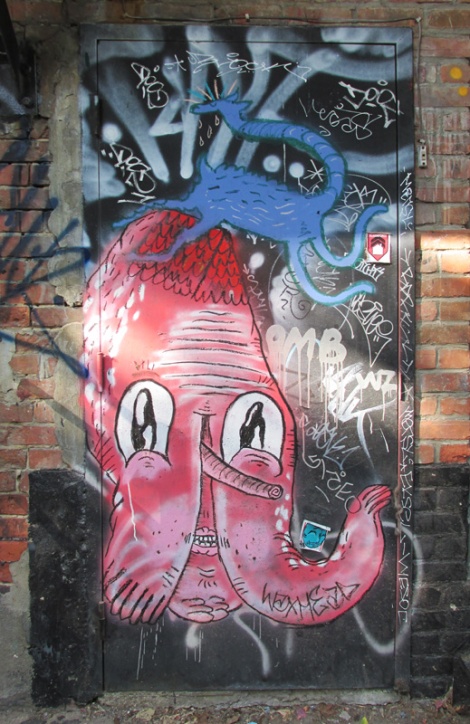 Waxhead (in red) and Cryote (in blue), and a lot of tags on door in alley between St-Laurent and Clark