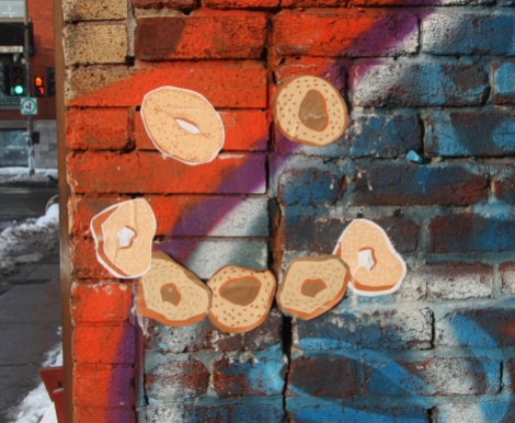 Pasted bagel prints at the St-Viateur end of the alley, artist unknown