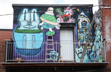 Collective work featuring Waxhead (left and bottom corner), Turtle Caps (above ladder), Futur Lasor Now (above door), Deadliest Rosa (flower) and El Moot Moot (right wall)