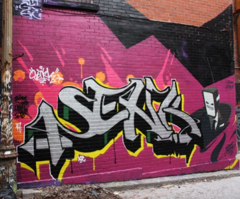 Senk on letters and Earth Crusher on character in a central Montreal alley